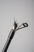 Close-up of a broken fishing rod tip guide in need of repair